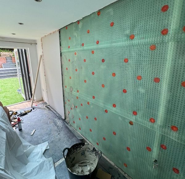Cavity drain membrane installed across a basement wall
